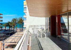 a balcony with a table and chairs and the beach at Apartamentos Santa Rosa Palmyra in Salou