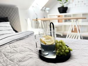 a glass of drink and grapes on a table at Ach to tu Apartament in Ostróda