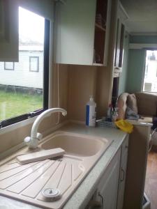 a kitchen counter with a sink and a window at River Views Dog friendly caravan 3 bedrooms in Rye