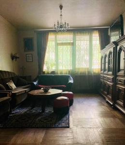 a living room with a couch and a table at Homestay Happiness in Tbilisi City