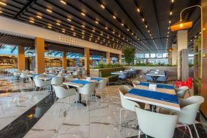 Un comedor con mesas y sillas en un restaurante. en Eftalia Aqua Resort, en Konaklı
