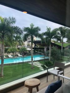 a room with a view of a pool and palm trees at Luxury condo in cap cana in Punta Cana