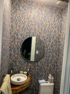 La salle de bains est pourvue d'un lavabo, d'un miroir et de toilettes. dans l'établissement Luxury condo in cap cana, à Punta Cana
