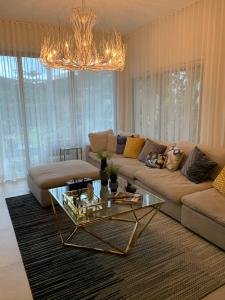 a living room with a couch and a glass table at Luxury condo in cap cana in Punta Cana