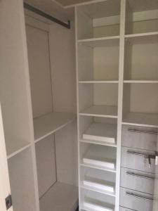 a walk in closet with white shelves at Luxury condo in cap cana in Punta Cana