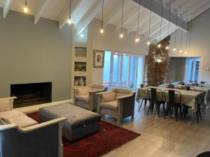 a dining room with a table and chairs and a fireplace at Serene Place Guest House & Conference Venue AFFORDABLE LUXURY WITH BACKUP POWER in Roodepoort