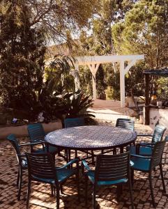a table and chairs with a table and a white pergola at casa paz tavira in Tavira