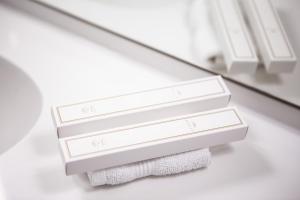 a stack of three white towels on a shelf at Ibis Kaunas Centre in Kaunas