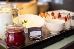 a tray with a bowl of rice and a bowl of sauce at Ibis Kaunas Centre in Kaunas