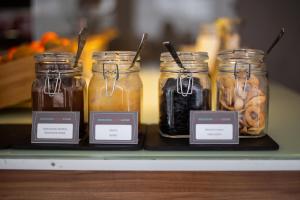 a group of jars of food on a shelf at Ibis Kaunas Centre in Kaunas