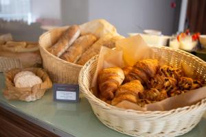 two baskets filled with different types of bread on a counter at Ibis Kaunas Centre in Kaunas