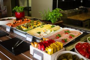 a buffet line with many different types of food at Ibis Kaunas Centre in Kaunas