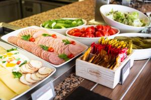 a buffet with different types of food on a counter at Ibis Kaunas Centre in Kaunas