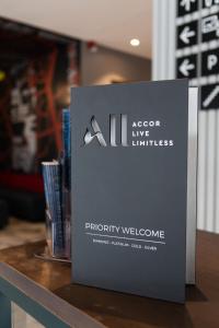 a sign for a book on a table at Ibis Kaunas Centre in Kaunas