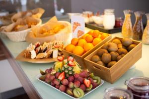 a buffet with different types of fruit on a table at Ibis Kaunas Centre in Kaunas