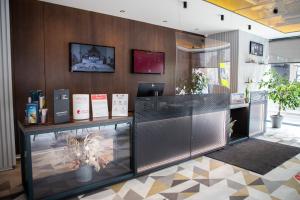 a lobby with a desk with a computer on it at Ibis Kaunas Centre in Kaunas