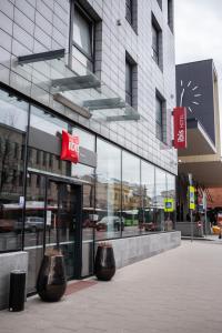 a building with two large vases in front of it at Ibis Kaunas Centre in Kaunas