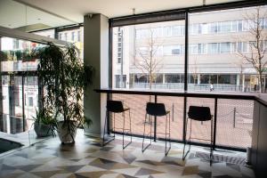 a room with chairs and windows in a building at Ibis Kaunas Centre in Kaunas