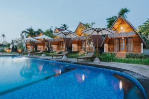 a resort with a swimming pool in front of it at Sundi Hill Cottage in Nusa Penida