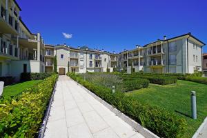 a sidewalk in front of a row of apartment buildings at Corte Fasanella 78 in Toscolano Maderno