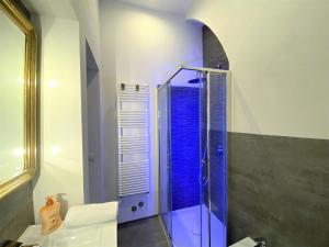 a bathroom with a shower with blue glass at WHITE HOUSE STALLOREGGI-vicino alla Cattedrale in Siena +30 photos
