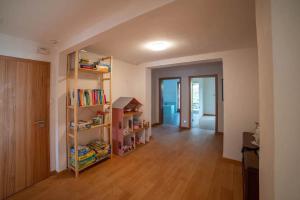 a room with a book shelf and a hallway at Ferienwohnung Am Waldrand in Bad Driburg