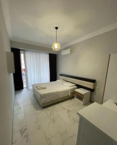 a bedroom with a bed and a chandelier at Günaydın Otel Alanya in Alanya