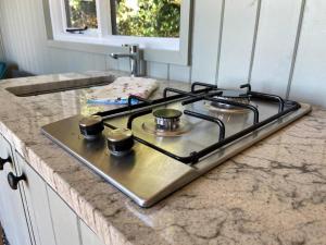 a stove top oven sitting on top of a counter at Little Idyll shepherds hut in Chester