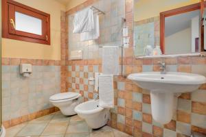 a bathroom with a sink and a toilet at Il Nuovo Gabbiano in Cala Gonone