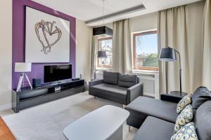a living room with a heart painting on the wall at Executive Apartment with Sauna by Grand Apartments in Sopot