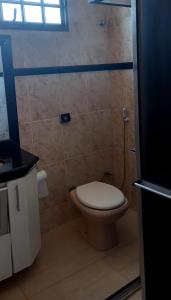 a bathroom with a toilet and a shower at suítes economy uberlandia in Uberlândia