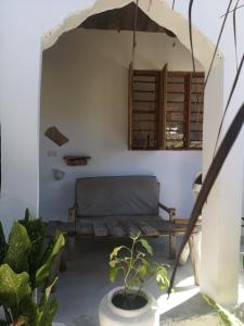 a room with a bench and a window at Wow Beach House in Jambiani