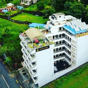 an aerial view of a white building with a balcony at Hotel Kunja in Pokhara