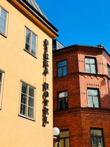 a building with a sign on the side of it at Birka Hotel in Stockholm