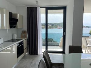 a kitchen with a view of the water at Premier Laguna Apartment in Lovište