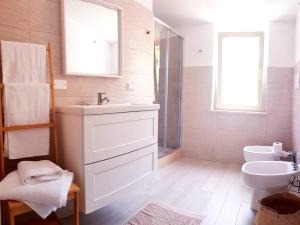 a white bathroom with a sink and a toilet at Casa Vacanza Mata in Zambrone