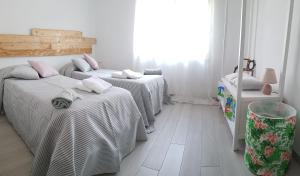 a room with three beds and a window at Casa Vacanza Mata in Zambrone