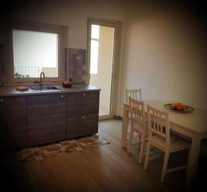 a kitchen with a sink and a table and chairs at Casa Vacanza Mata in Zambrone +17 photos
