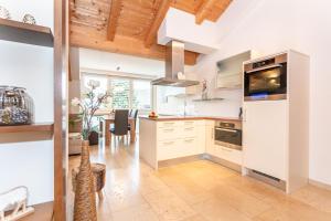 a kitchen with white appliances and a dining room at Doris Appartements in Neukirchen am Großvenediger