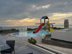 a playground with a slide in a pool at Edificio Reserva del Mar, Paya Salguero , Santa marta in Gaira