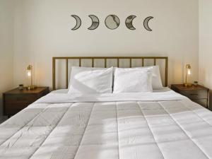 a bedroom with a large white bed with two night stands at Clover Luxury High-Rise DownTown South Bend in South Bend