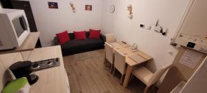 a small living room with a table and a couch at Apartament Miruna Sibiu Filarmonicii in Sibiu