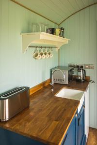 a kitchen with a sink and a counter top at Mulsford Cottage in Malpas