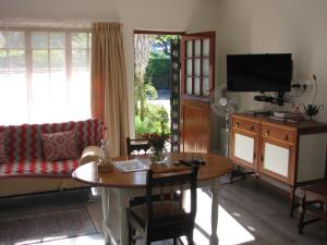 a living room with a table and a couch at Kaiser's B&B in Grahamstown