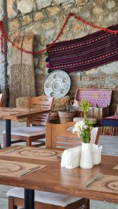 a table with wooden tables and chairs in a room at Dalya Resort Aqua & Spa Hotel Datça in Datca