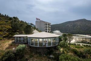 a house on top of a hill with a building at Dalya Resort Aqua & Spa Hotel Datça in Datca