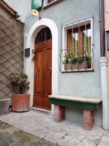 a house with a wooden door and a window at Casa di Laura in Chianciano Terme