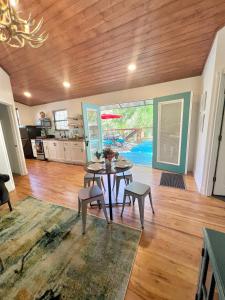 a kitchen and dining room with a table and chairs at Getaway Oasis w/Huge Deck + pool/spa - lake conroe in Willis