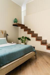 a bedroom with a bed and a staircase at InCanto in Palermo
