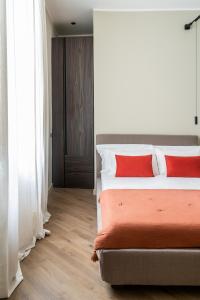 a bedroom with a bed with two red pillows at InCanto in Palermo